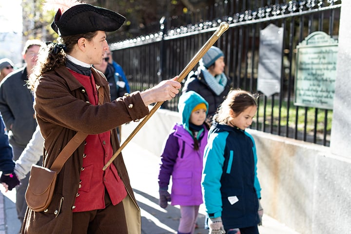 A guide touring visitors at the Freedom Trail in Boston
